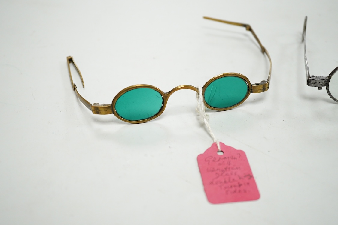 A pair of 18th century steel temple spectacles, a similar pair of iron spectacles, with written note dating them to 1796, and a pair of German? brass framed spectacles with green tinted lenses (3)